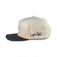The Breakfast Ball Snapback Hat by Logie Joe's Golf features a structured beige and black design with orange trim, small ventilation holes, a flat brim, side embroidery, and a built-in magnet for the matching golf ball marker.