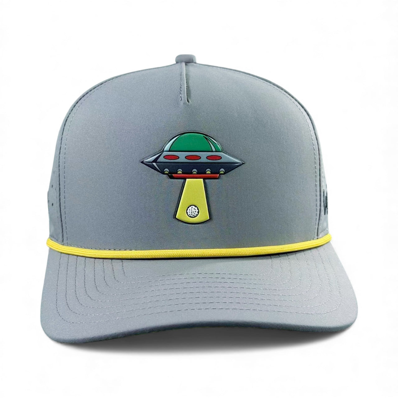 Logie Joe's Golf UFO Golf Hat in Alien Gray is a snapback cap featuring a colorful UFO beaming down a golf ball, with a yellow cord accent, built-in magnetic ball marker holder (marker included), and adjustable fit.