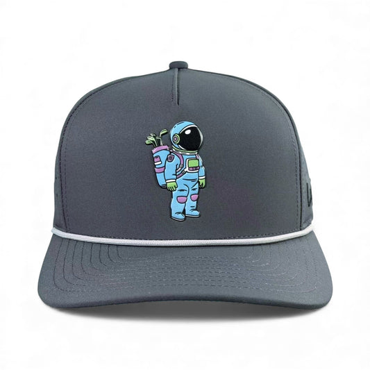 The Logie Joe's Golf Astronaut Walker Golf Hat is a dark gray snapback cap featuring a colorful cartoon astronaut with a green plant, plus a built-in magnetic ball marker holder and included marker—great for golf or casual wear.