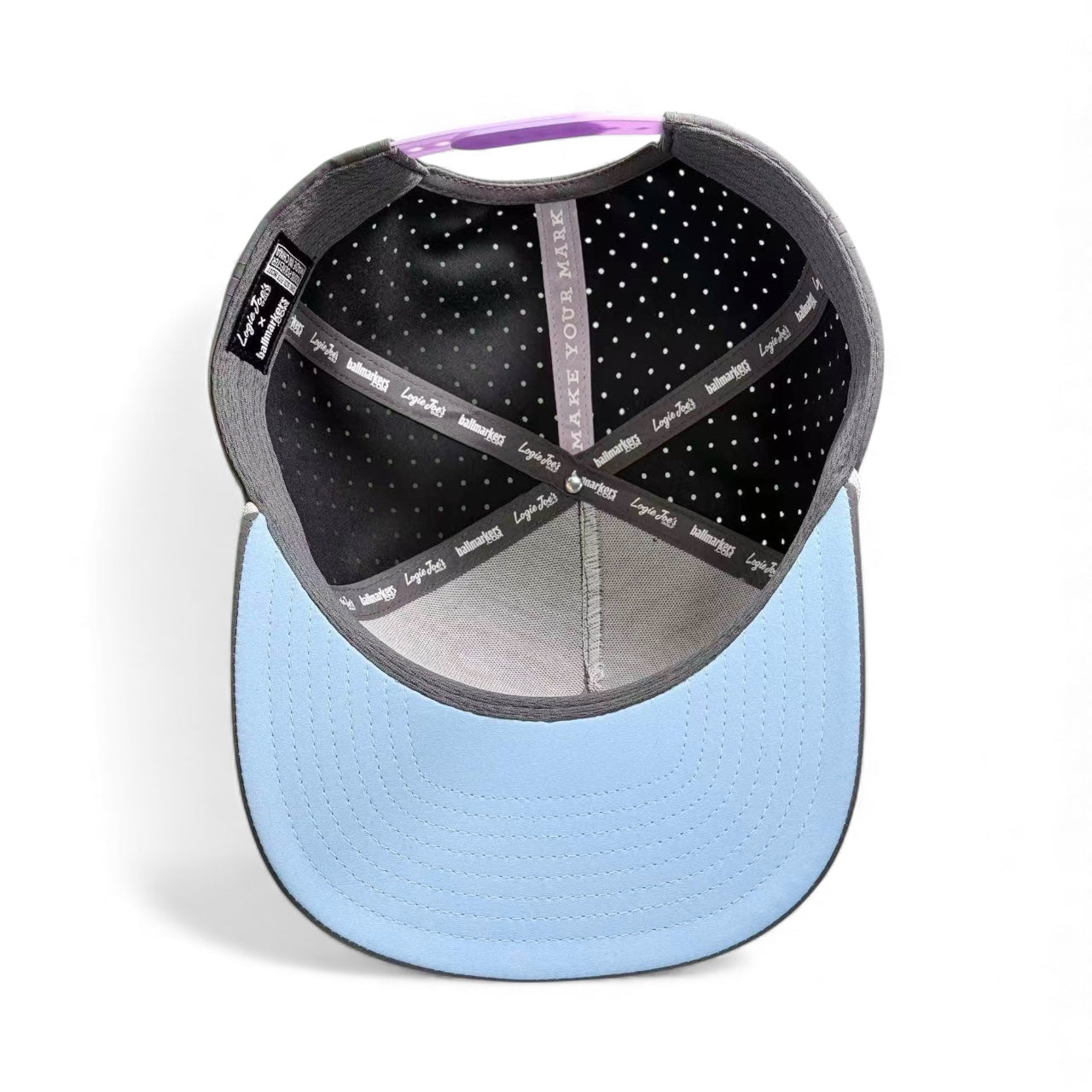 The interior of the Logie Joe's Golf Astronaut Walker Golf Hat shows gray, black, and white polka dot panels with visible black labels. This adjustable snapback cap features a built-in magnetic ball marker holder—ideal for any golf hat collection.