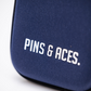 A close-up of the Glove & Accessory Caddie - Navy by Pins and Aces, featuring bold white branding on the front—a stylish accessory caddy for your golf essentials.