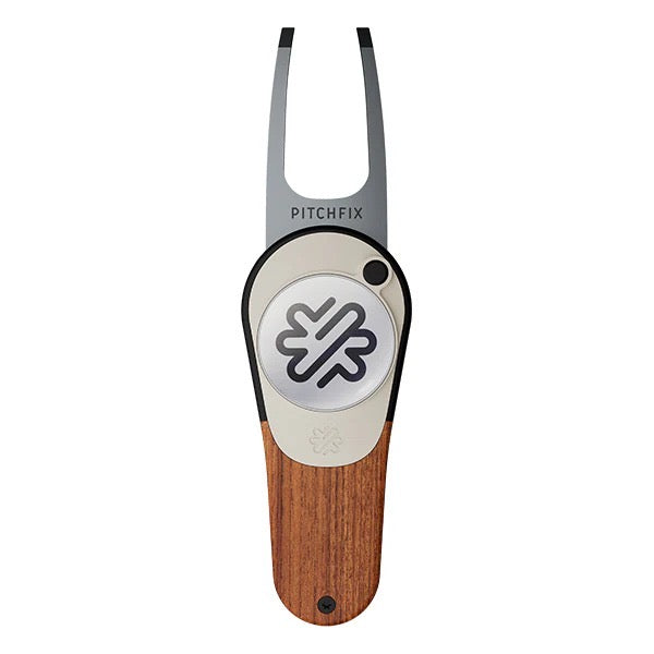 The PitchFix Woodie Divot Tool features wood-effect styling, a wooden handle, metal prongs with "PITCHFIX" branding, and a round silver button displaying a black geometric logo.
