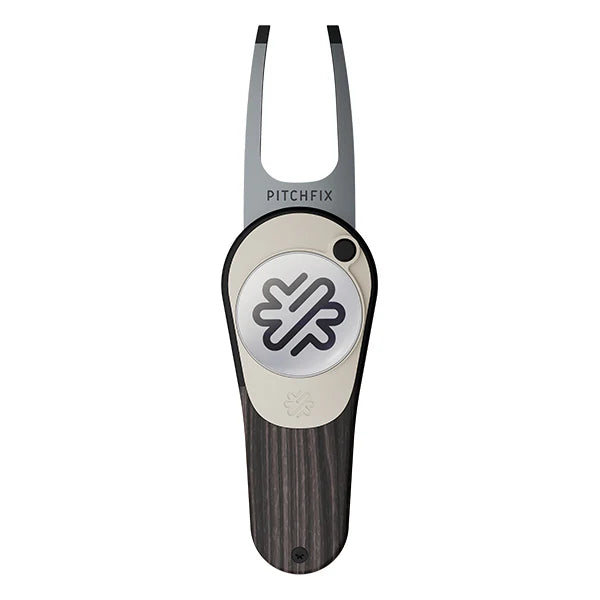 The PitchFix Woodie Divot Tool features a stylish dark wood-effect handle, silver circular emblem with geometric logo, and 'PitchFix' branding near its forked metal end.