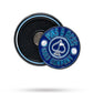 A thin, navy Pop Out Medallion Ball Marker by Pins and Aces, featuring "PINS & ACES GOLF COMPANY" and golf ball designs, shown next to its circular holder.