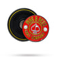 The Pins and Aces Pop Out Medallion Ball Marker - Red features a round, red and yellow design with "PINS & ACES GOLF COMPANY" text and an ace of spades symbol, positioned on a black magnetic base.