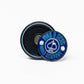 The Pop Out Medallion Ball Marker - Navy by Pins and Aces is a round, thin marker in blue and black with the brand name and ace of spades logo. It stands upright, showcasing its magnetic back on a white background.