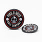 The Pop Out Medallion Ball Marker - Black by Pins and Aces features round black and red ball markers with ace of spades symbol; one stands upright while the other lies flat.