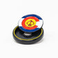 The Pop Out Medallion Ball Marker - Colorado by Pins and Aces features the state flag design with a yellow spade center, displayed on a black circular base against a white background.