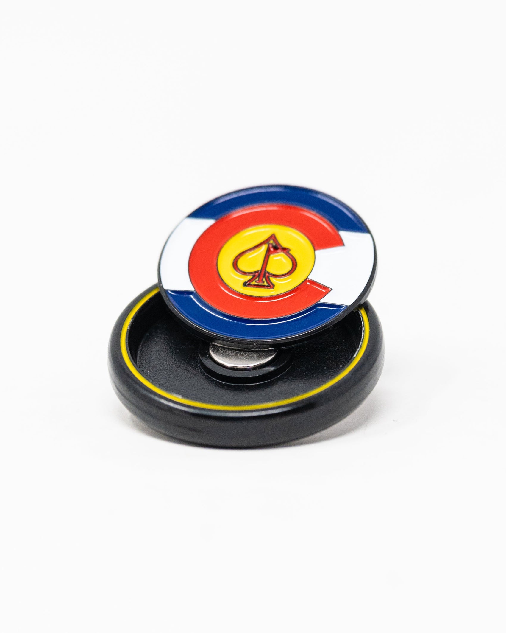 The Pop Out Medallion Ball Marker - Colorado by Pins and Aces features the state flag design with a yellow spade center, displayed on a black circular base against a white background.
