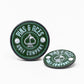 Two green Pop Out Medallion Ball Markers by Pins and Aces, each with a white spade symbol and branding; one stands upright while the other lies flat, showcasing a stylish golf accessory on a white background.