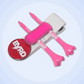 The Byrd, LLC’s THE BYRD GOLF CLYP - White Swan set includes two pink and white tees, a red BYRD ball marker, and a white divot tool with pink grip, all displayed on a light blue circular background.