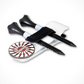 Two free tees are held together on The Byrd, LLC’s THE BYRD GOLF CLYP - White Swan ball marker holder with a black strap. A round marker with a red and white geometric pattern is placed next to the holder.
