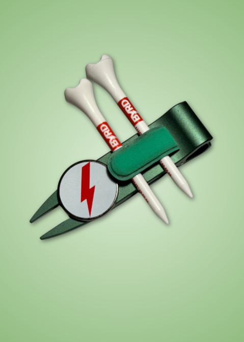THE BYRD GOLF DIVOT CLYP by The Byrd, LLC: A green accessory holder with two white BRAND tees and a metal divot tool marked with a red lightning bolt, set on a light green gradient. Hot item—stock is low, so grab yours now!.