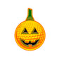 The Pumpkin Golf Ball Marker by Ballmarkers.com features a jack-o’-lantern design with golf ball texture, triangular eyes, a jagged smile, and a green stem on a white background.