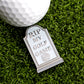 The RIP My Golf Game Tombstone Ball Marker by Ballmarkers.com, engraved with "RIP MY GOLF GAME" and a rose, rests beside a golf ball on artificial grass—an unforgettable accessory for any golfer.