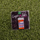 The RX Putterall is a golf ball marker shaped like a prescription pill bottle, labeled “Take 3 Daily.” Set on artificial grass with Logie Joe’s Golf branding, it’s a unique accessory for any golfer.