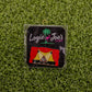 Add some laughter to your game with Logie Joe's Golf "Sh*t Show"—a colorful stage enamel pin with red curtains and a poop emoji center, displayed on grass. One of the funniest golf ball markers and accessories around!.