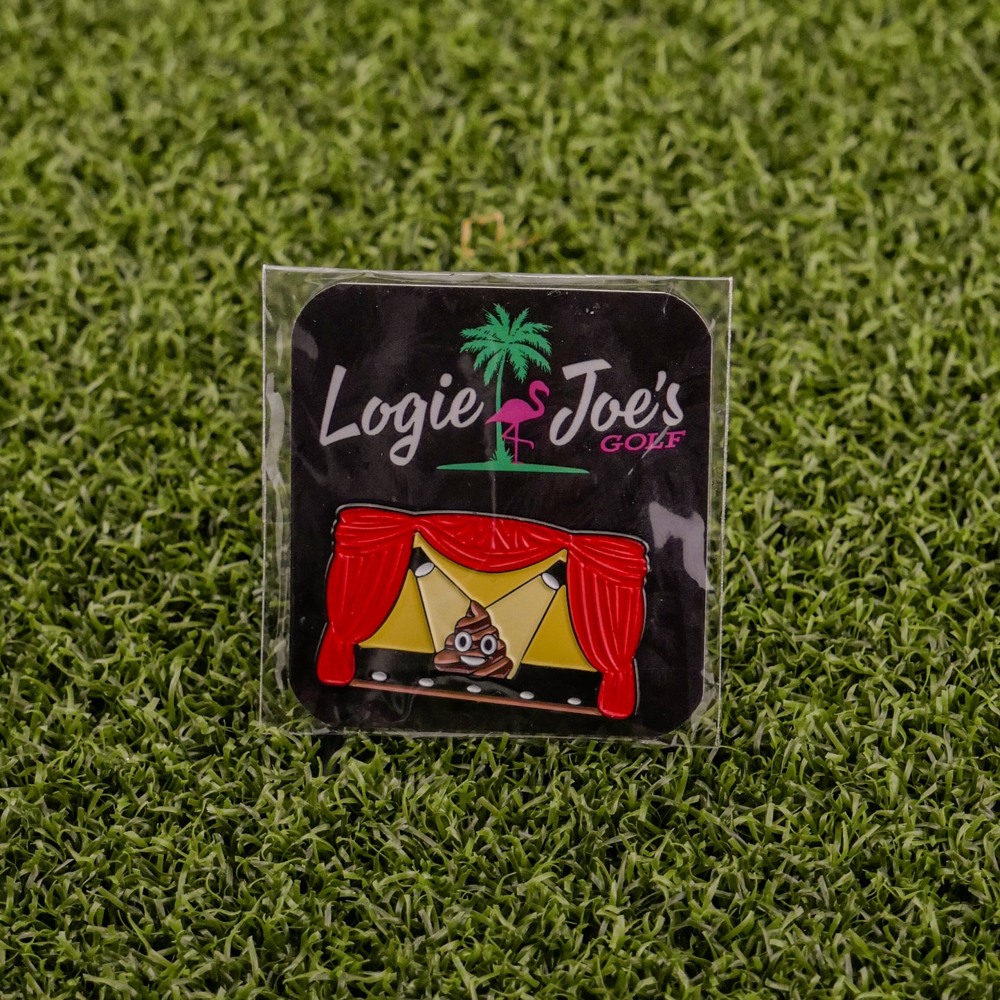 Add some laughter to your game with Logie Joe's Golf "Sh*t Show"—a colorful stage enamel pin with red curtains and a poop emoji center, displayed on grass. One of the funniest golf ball markers and accessories around!.