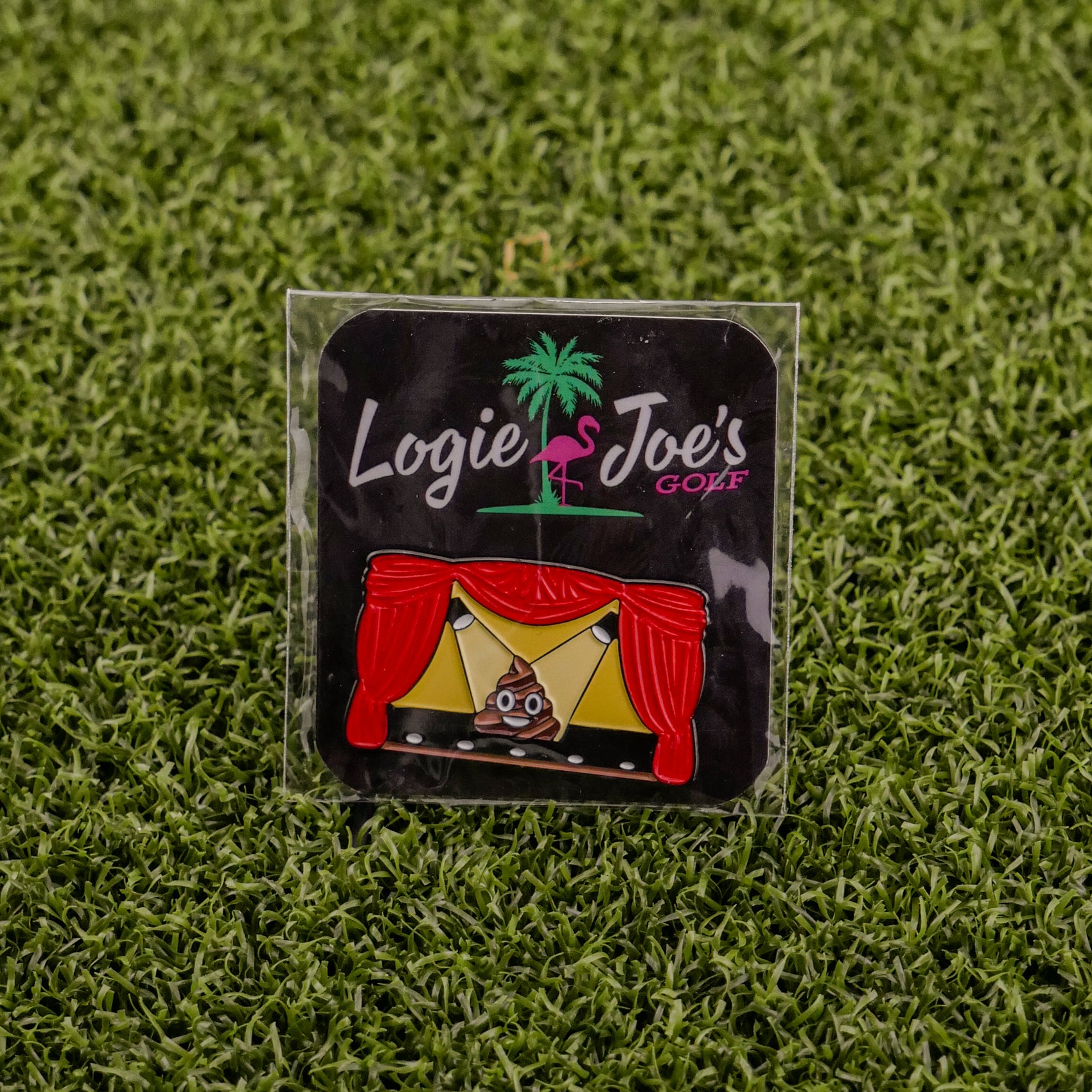 Add some laughter to your game with Logie Joe's Golf "Sh*t Show"—a colorful stage enamel pin with red curtains and a poop emoji center, displayed on grass. One of the funniest golf ball markers and accessories around!.