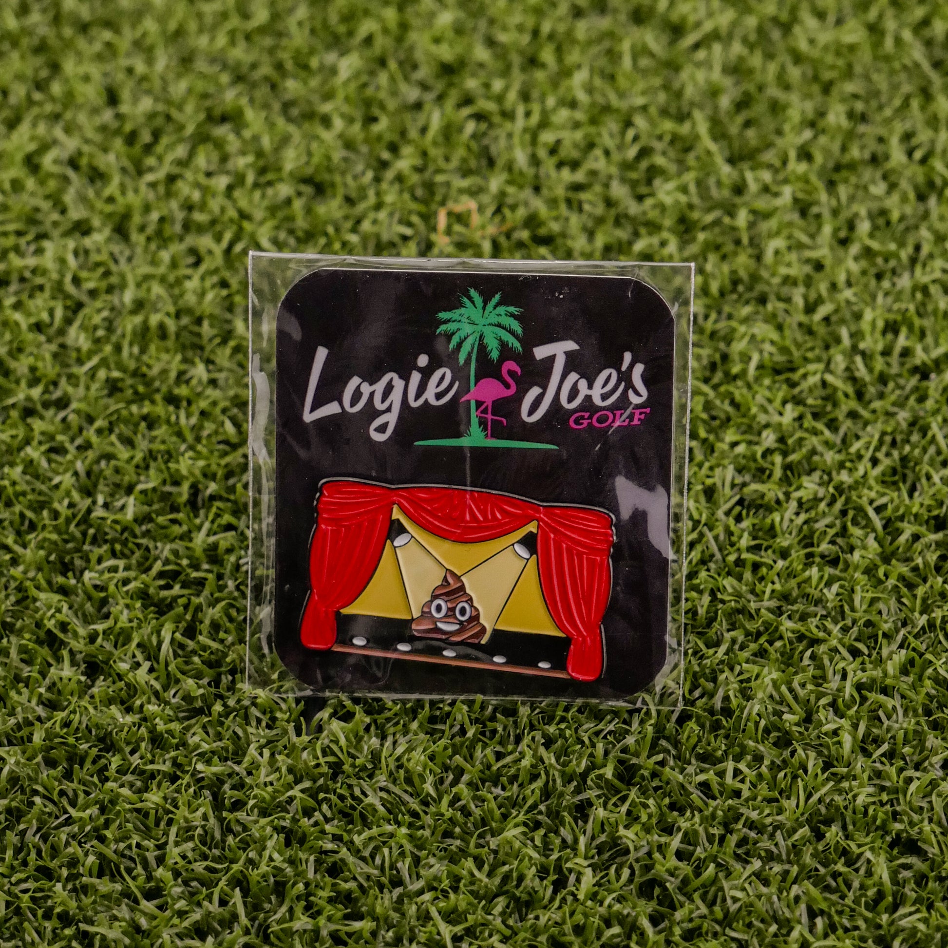 Add some laughter to your game with Logie Joe's Golf "Sh*t Show"—a colorful stage enamel pin with red curtains and a poop emoji center, displayed on grass. One of the funniest golf ball markers and accessories around!.
