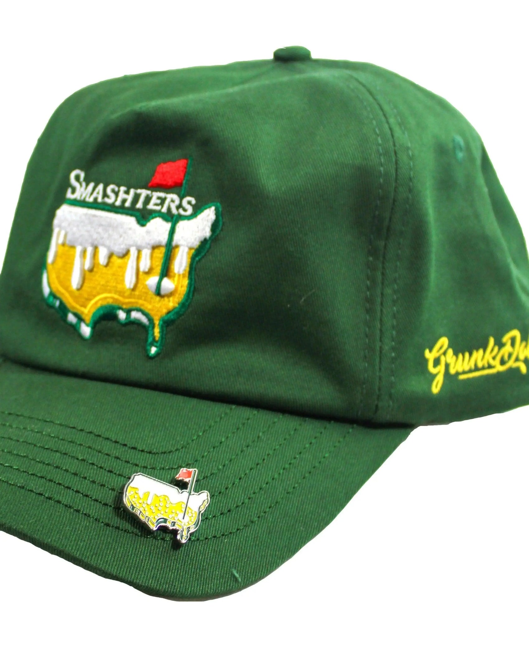 The Smashters Ball Marker by Grunk Dolfer is a green cap with an embroidered beer logo, red flag, and "SMASHTERS." "Gronkd" is stitched on the side, and it features a magnetic golf ball marker—ideal for unique golf gifts.