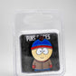 The South Park Ball Marker - Stan by Pins and Aces features Stan in his blue and red hat with a brown jacket, packaged in clear plastic as part of the South Park golf accessories collection.