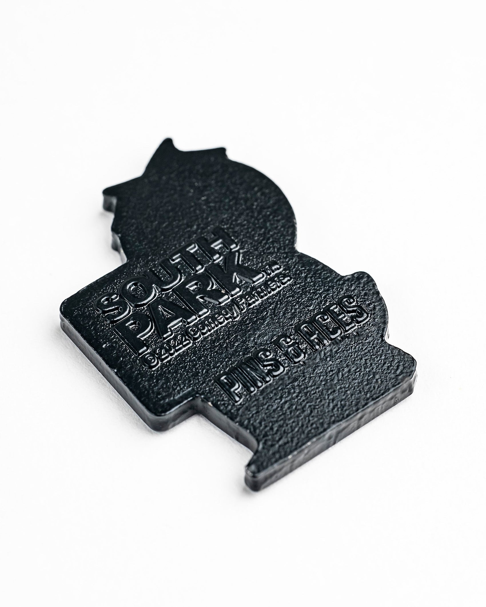 The South Park Ball Marker - Butters by Pins and Aces is a black, textured pin featuring embossed South Park branding—an ideal accessory for fans seeking official golf gear or premium ball markers.