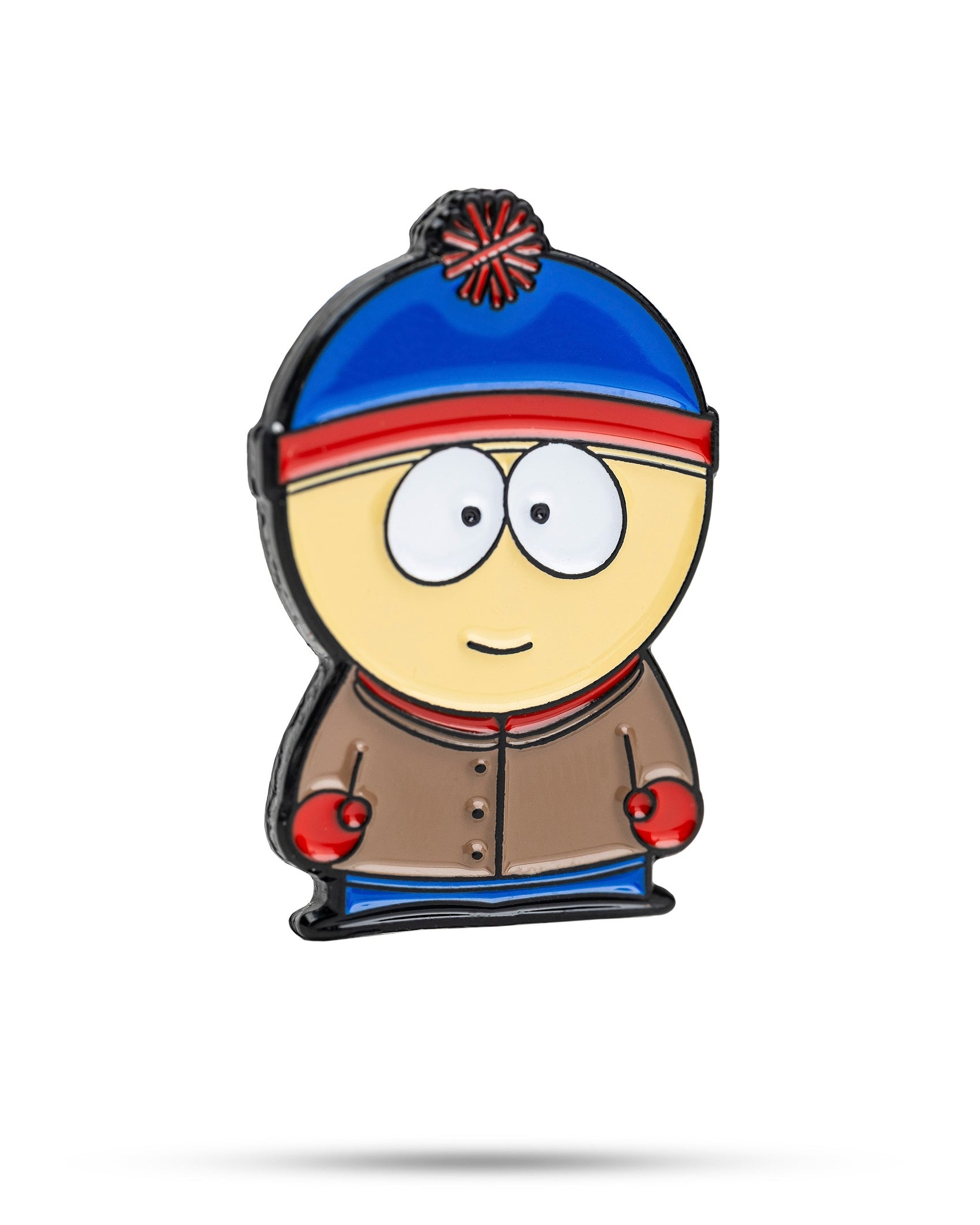 The South Park Ball Marker - Stan by Pins and Aces features Stan with a blue and red beanie, brown jacket, red mittens, and big eyes—perfect for fans of South Park golf accessories.