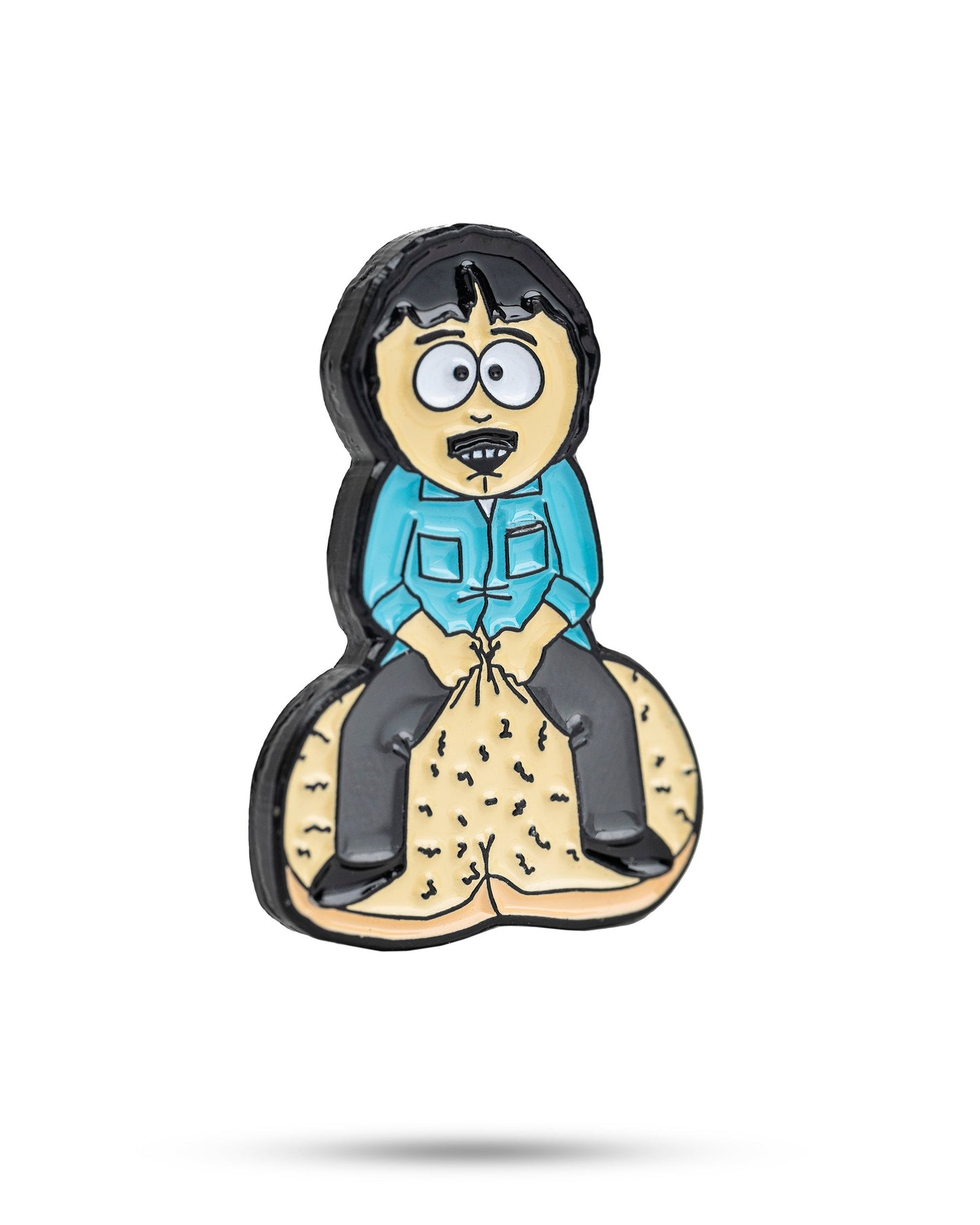 The South Park Ball Marker - Randy by Pins and Aces is a cartoon-style pin showing Randy with black hair and a mustache, sitting on two large golf balls—ideal for fans of premium ball markers.