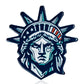 The Pins and Aces Statue of Liberty - Ball Marker features a blue, white, and green stylized illustration of Lady Liberty’s head with her iconic crown, ideal for adding inspiration to your golf game. Set against a clean white background.