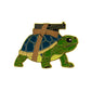 A cartoon turtle with a blue and green shell carries Logie Joe's Golf Strapped Turtle Ball Marker, designed to look like a RANGER walkie-talkie strapped on its back with brown bands. The image features a white background.