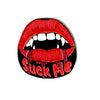 The Suck Me Ball Marker by Logie Joe's Golf features red lips with fangs and dripping blood over a black background with "Suck Me" in red—a fun, spooky enamel pin and golf accessory perfect for your next Halloween round.
