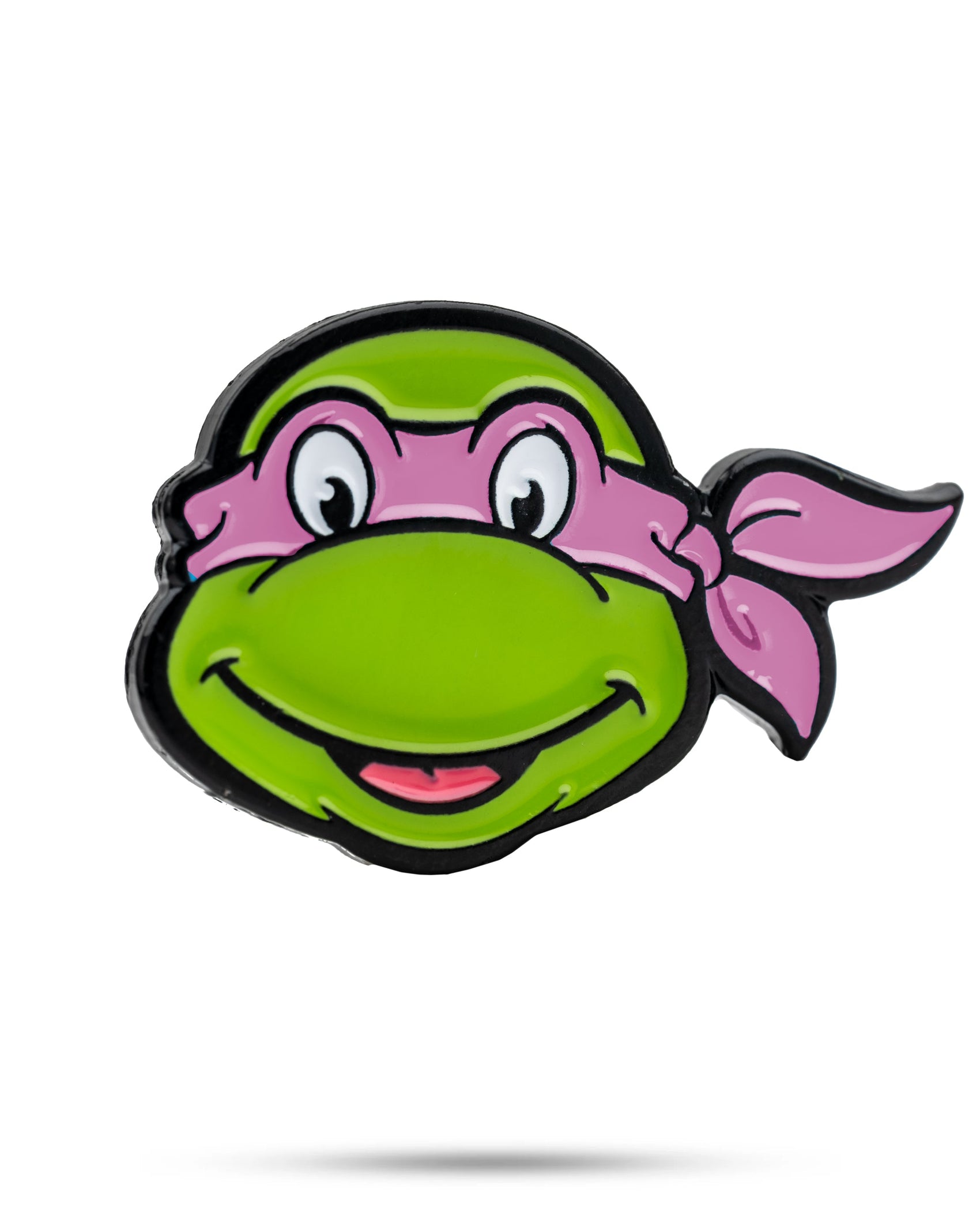 Show off your TMNT fandom with the Pins and Aces TMNT - Donatello Ball Marker—a smiling green turtle head with a pink mask and bandana on a white background, perfect for adding fun to your golf game.