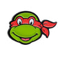 Show your TMNT pride on the golf course with the TMNT - Raphael Ball Marker by Pins and Aces—a cartoon-style green turtle head with red mask and bandana, perfect for any Teenage Mutant Ninja Turtles fan.