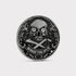The Omen Classic Antique, Diamond & Silver Edition by Doubloon is a round, metallic golf marker with a lab-grown diamond skull, crossed bones, intricate edge detail, and “MARKS THE SPOT” engraved at the bottom.