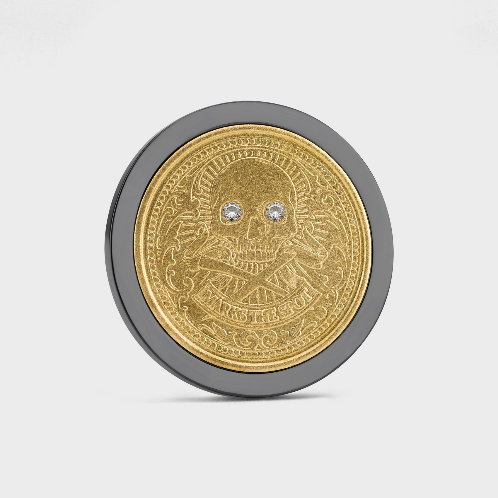The Omen Classic by Doubloon features a gold doubloon with a skull and crossbones, jeweled eyes, ornate patterns, and "MARKS THE SOUL" engraved below, set in a black titanium rim against a white background.