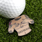 Add fun to your golf game with Logie Joe's Golf Titties & Tattoos ball marker—a premium accessory shaped like a tattooed, topless torso with hands covering the chest and "Titties & Tattoos" lettering.
