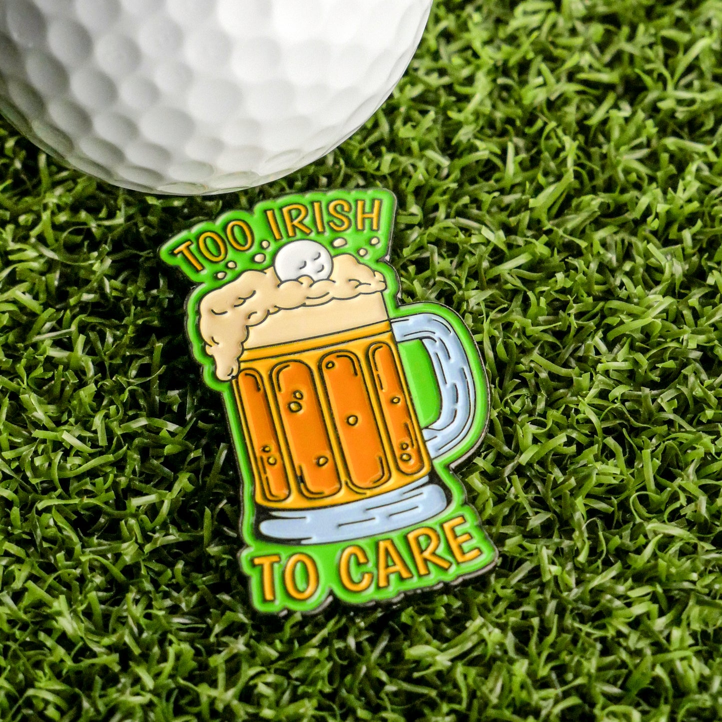 The Ballmarkers.com "Too Irish To Care Ball Marker" features a frothy beer mug and golf ball on grass with bold green and yellow text—an ideal Irish golf gift or fun marker for St. Patrick’s Day rounds.