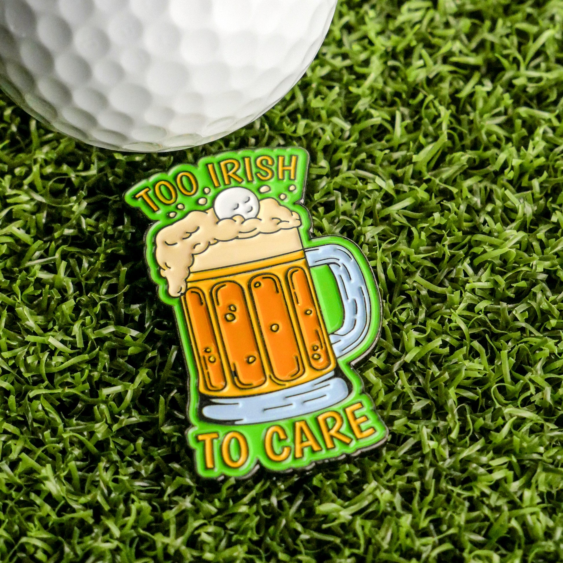 The Ballmarkers.com "Too Irish To Care Ball Marker" features a frothy beer mug and golf ball on grass with bold green and yellow text—an ideal Irish golf gift or fun marker for St. Patrick’s Day rounds.