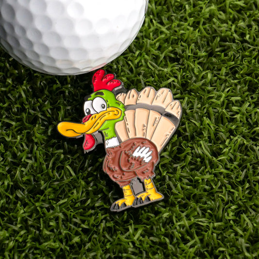 The Turducken Ball Marker by Logie Joe's Golf is a funny Thanksgiving golf accessory, featuring a cartoon turkey pin with exaggerated features, perfect for marking your ball on the green.