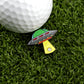 A golf ball rests on green grass beside Logie Joe's Golf UFO—a colorful, premium, UFO-shaped ball marker with a yellow beam pointing toward the ball.