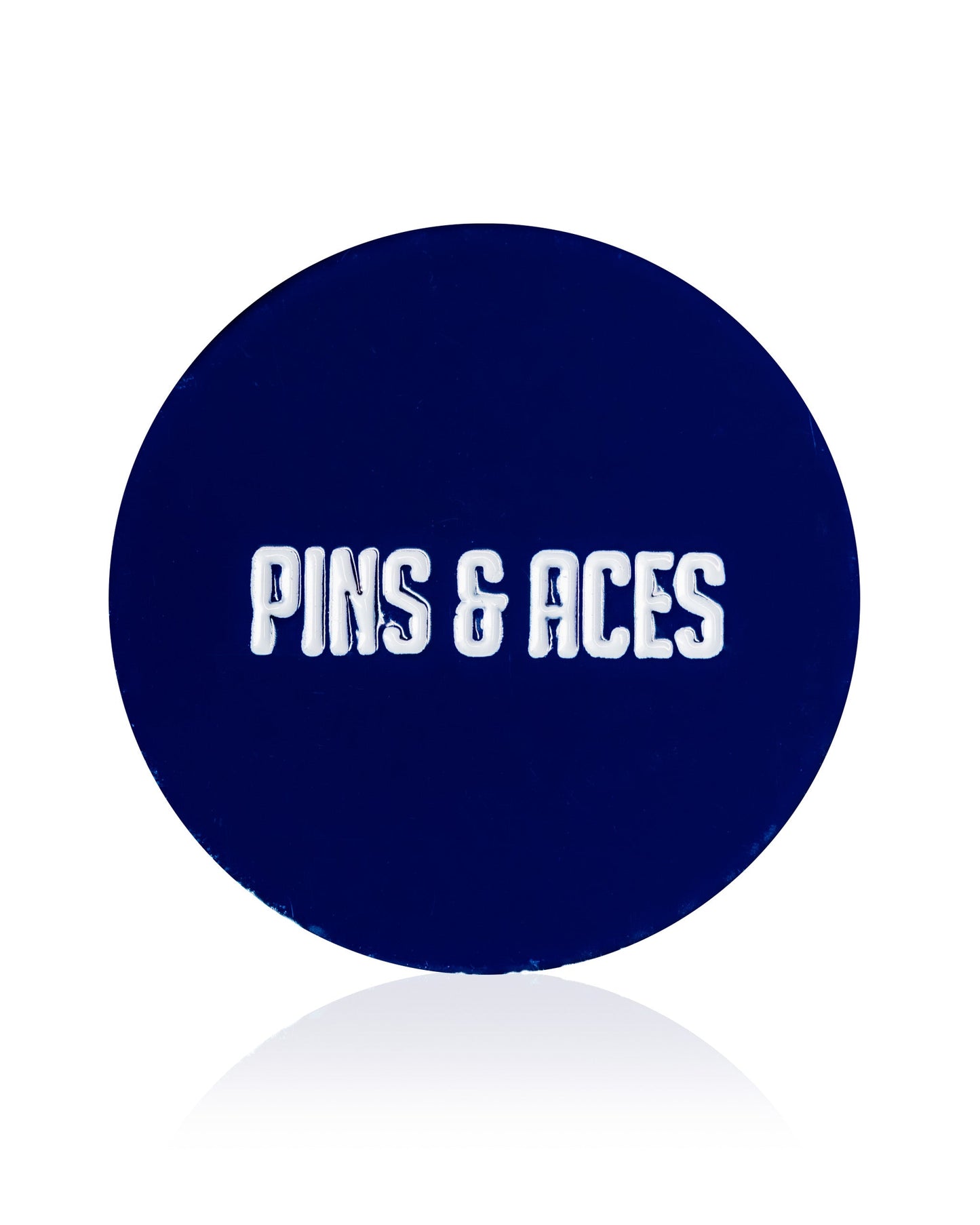 A dark blue circular "USA Soccer Ball - Ball Marker" by Pins and Aces, featuring an enamel finish and "PINS AND ACES" in bold white letters at the center.