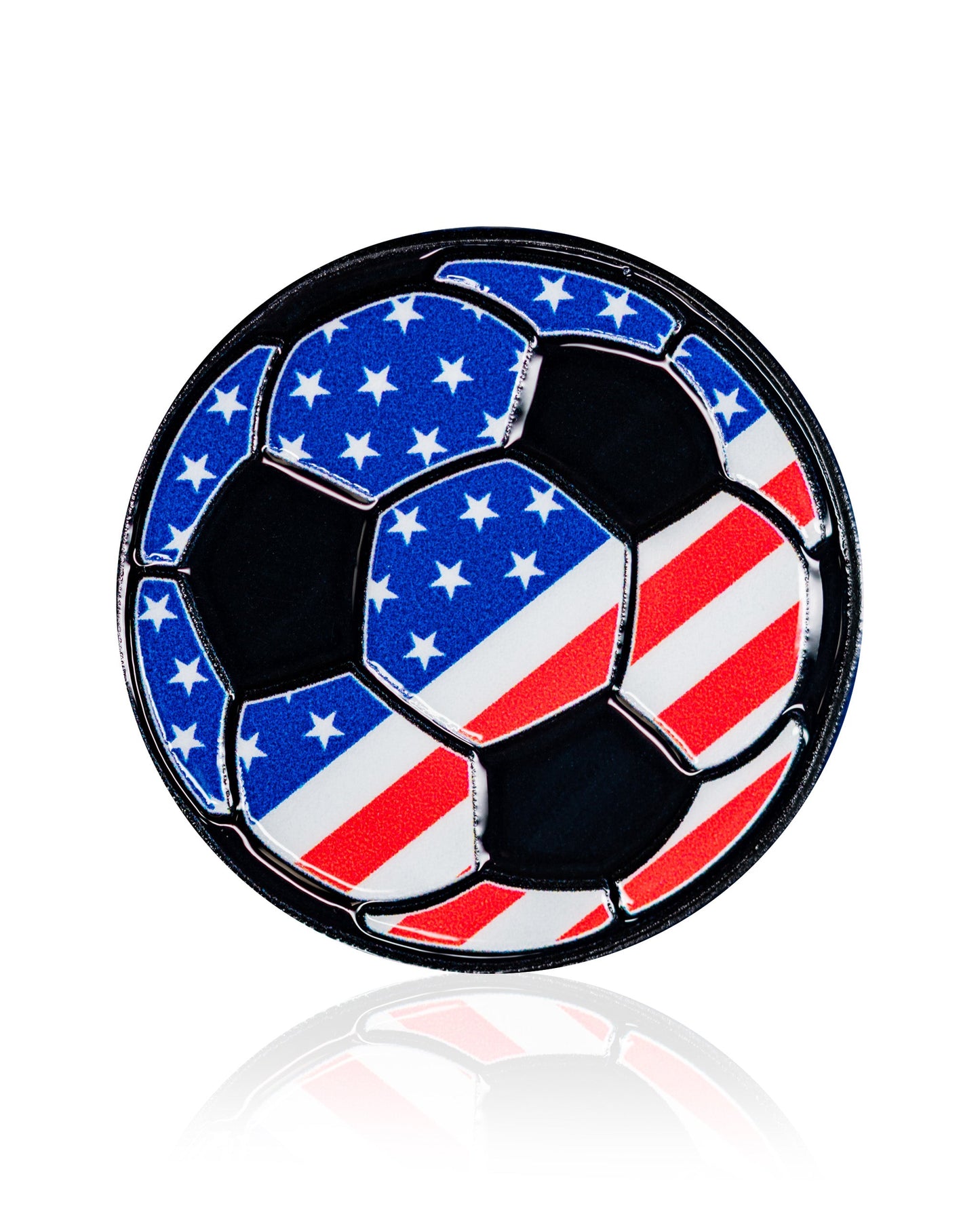 The USA Soccer Ball - Ball Marker by Pins and Aces features black pentagons and U.S. flag-inspired hexagons in a premium enamel finish. Shown on a white background with a subtle reflection below.