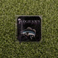 A square sticker featuring a walleye fish illustration and Logie Joe's Golf text on a dark background, set on green turf—ideal for golf enthusiasts seeking fun accessories or premium ball marker inspiration.