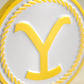 The Pins and Aces Yellowstone Ball Marker features a round, white and yellow design with a raised yellow Y and rope-like border—a must-have golf accessory for any player.