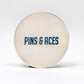 The 6 Milly - Cool Mint Ball Marker by Pins and Aces is a round, silver-colored accessory with the brand's name in blue enamel on the front, designed for marking golf balls, shown on a white background.