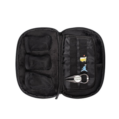 The Grunk Dolfer Grunk Accessory Bag is an open black zippered case with three mesh pockets for golf accessories, assorted pins, and a keychain labeled "Double like a cool chef" attached to the right-side straps.