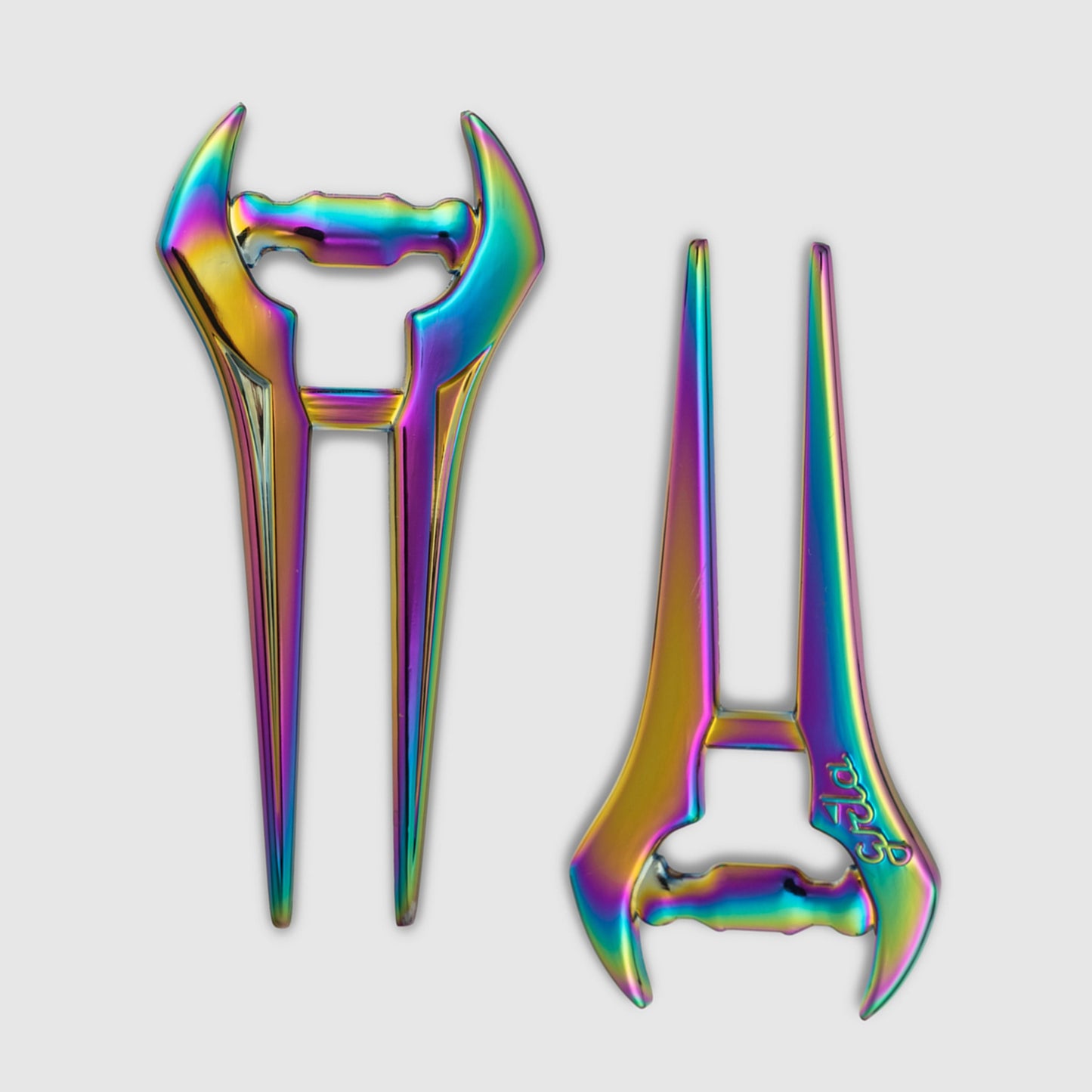 A pair of Guerrilla Golf E Sword Divot Tools—metallic hair sticks featuring a futuristic blade-like design and a vibrant iridescent rainbow finish—are displayed on a white background.