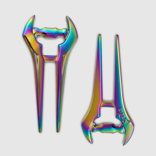 A pair of Guerrilla Golf E Sword Divot Tools—metallic hair sticks featuring a futuristic blade-like design and a vibrant iridescent rainbow finish—are displayed on a white background.
