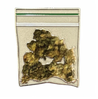 The Herb Ball Marker by Golf Gear Heaven is a small clear bag with greenish-brown faux buds and a green-striped zipper—ideal for marking your spot on the greens or using as a unique ball marker during Tee Bumps.